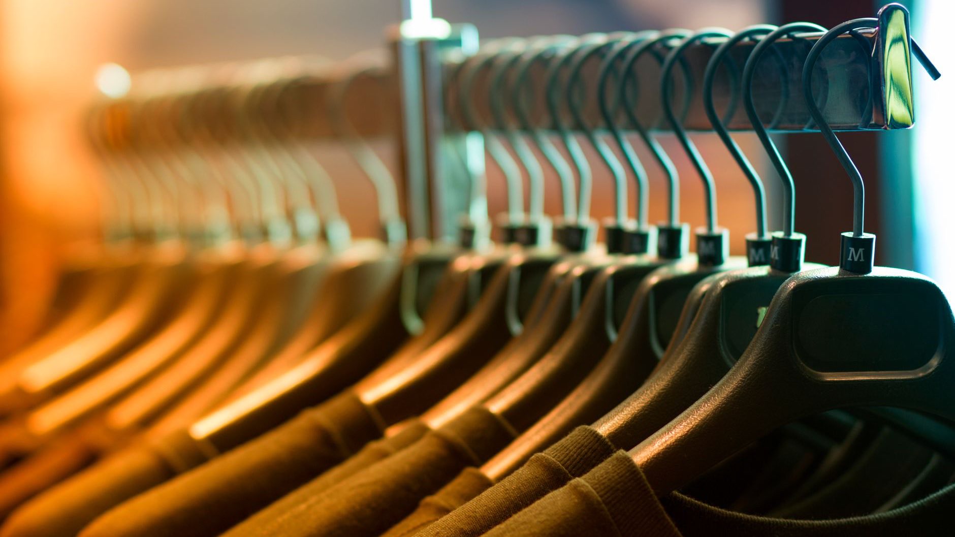 Wooden hangers under warm shop lighting
